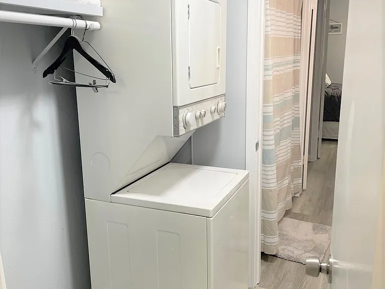 Washer and dryer inside condo off of full bathroom with new shower and tub.
