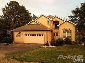This gracious home sits right on the lake across from the island
