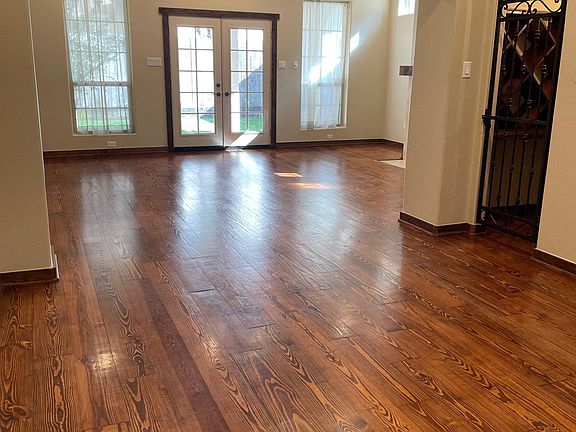 Open floor plan living and dining plus wine room with custom wine cases, under cabinet hanging glass rack and space for wine fridge/kegerator.