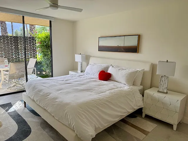 Primary bedroom with slider out to back patio and pool/spa.