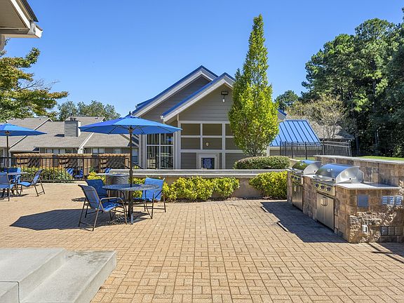 Outdoor entertainment space that's outfitted with a grilling station and abundant seating.