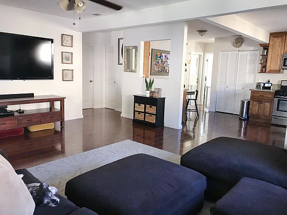 View from corner of living room showing adjacent hallway con