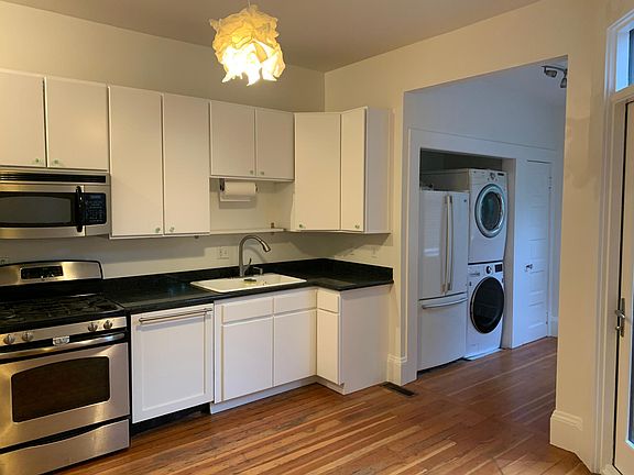 Standing in the kitchen, looking toward the laundry area.