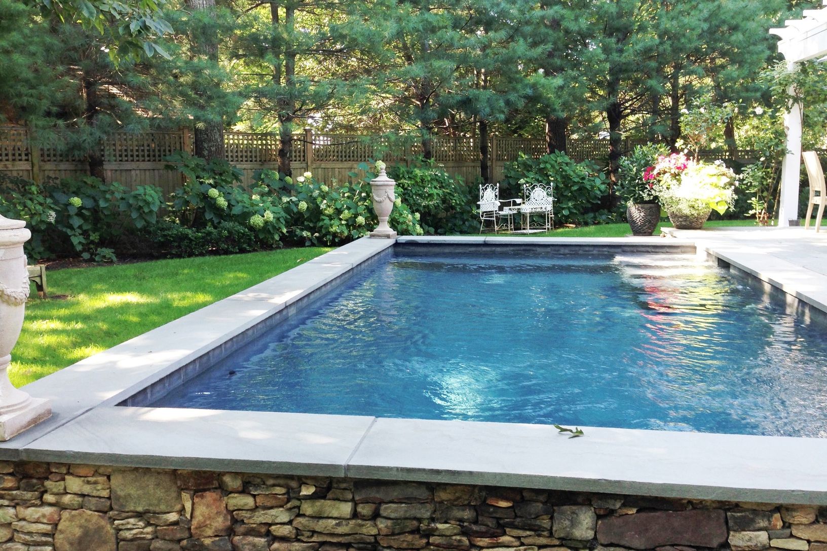 GUNITE POOL SURROUNDED BY ENGLISH STYLE GARDENS