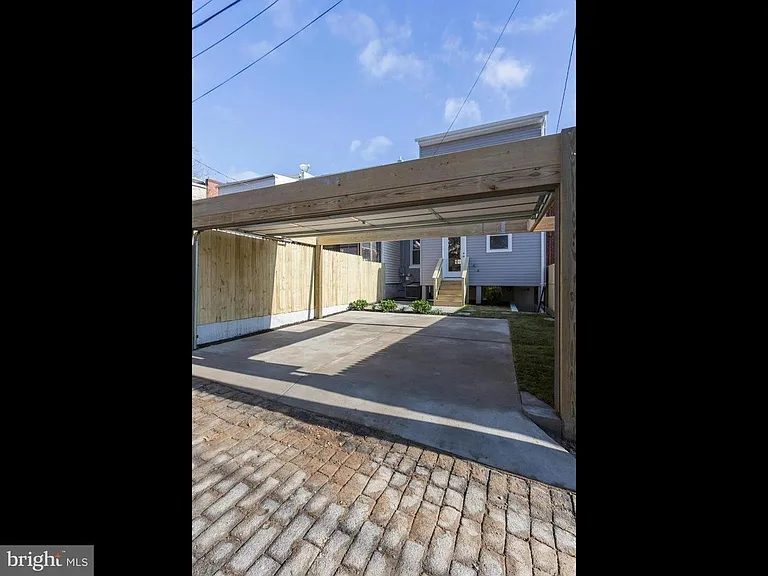 View from alley behind the house. 
 Dedicated, secure back yard with parking space. Great for grilling, herbs, relaxing!