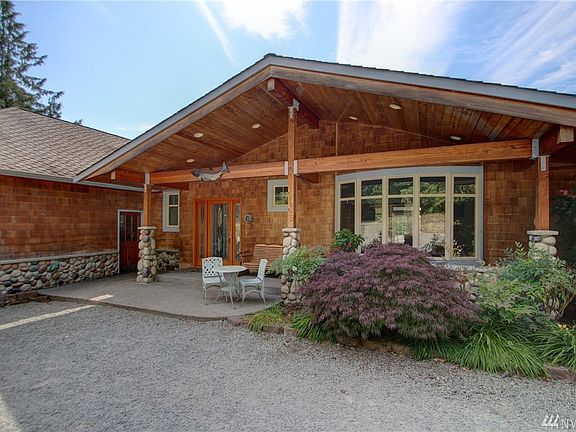 Covered entry porch with stone and wood accents to greet you