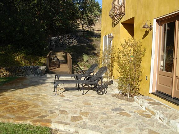 The side patio offers views of the vineyard and a relaxing way to enjoy the afternoon or sunset.