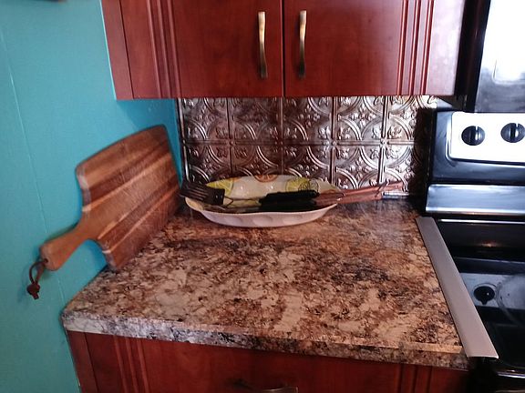 Recently remodeled kitchen provides the warmth and richness of cherry linoleum.