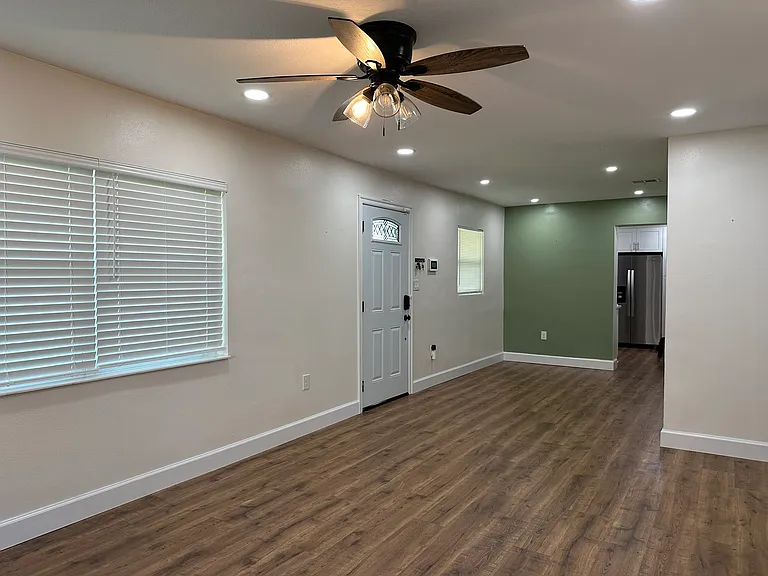 view from the living room towards the dining room and kitchen