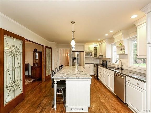Kitchen with custom glass doors to spacious Dining Room.