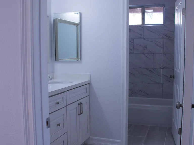 Newly renovated full bathroom upstairs with dual sinks.