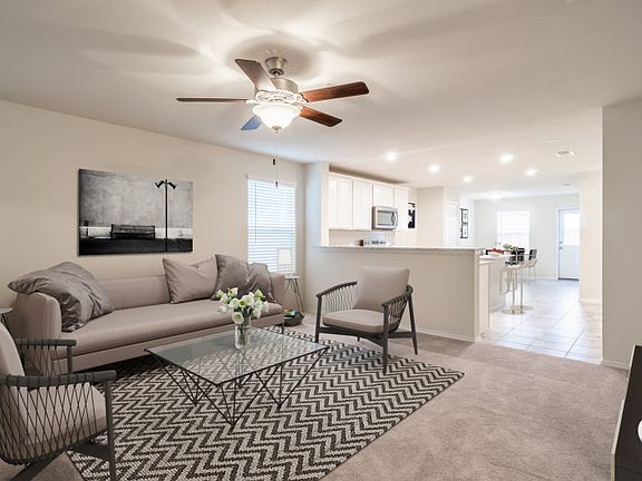 Model Representation - Spacious gathering room with view of kitchen