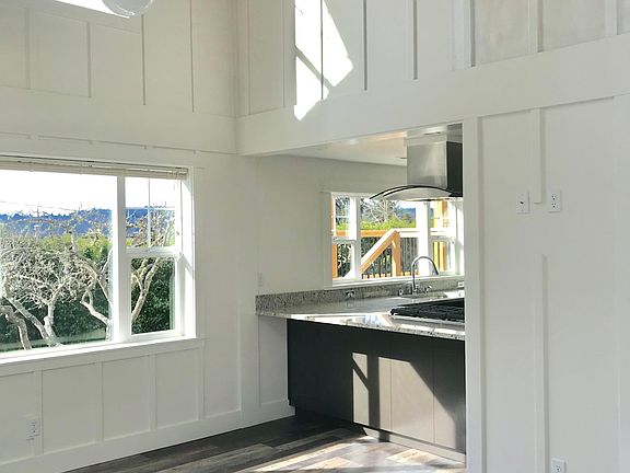 Open plan family room with clerestory windows and view from loft above