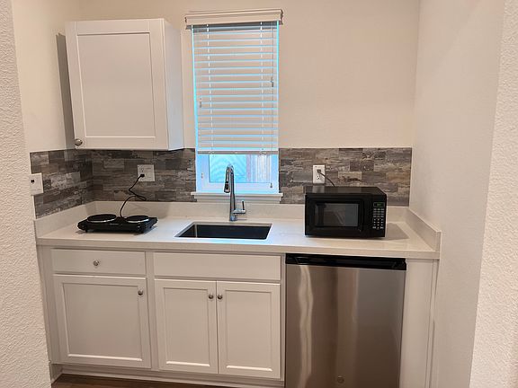 Kitchen with Electric Stove, Mini Fridge and Microwave