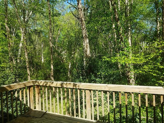 Deck with storage closet.  Overlooks wooded area.