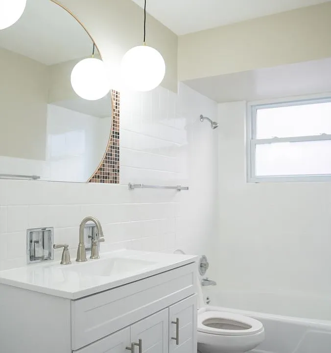 Full bathroom with pendant lights