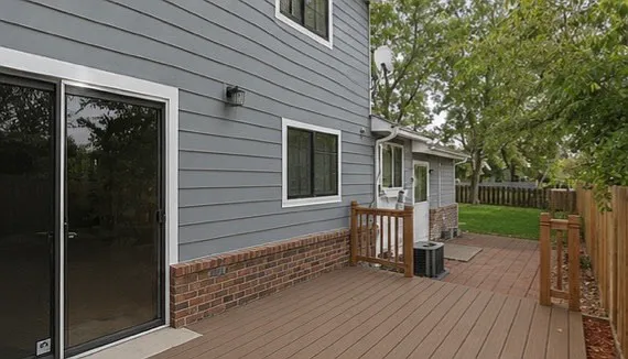 Deck and paver patio off of the kitchen and garage