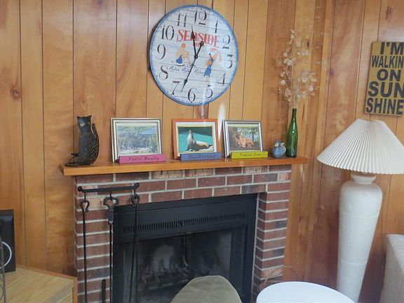 Living area with wood-burning fireplace.