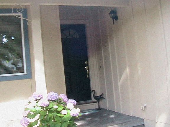 Fenced front entry to private patio and front door