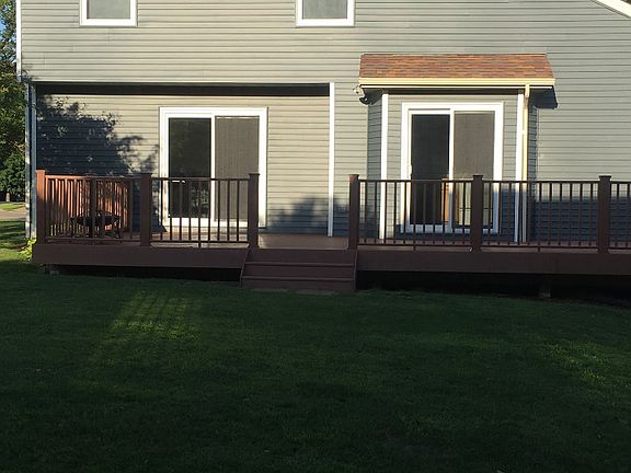 Back of house with large composite deck