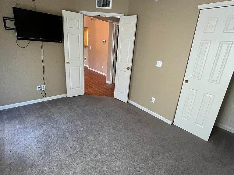 View looking out to the hallway from the second bedroom