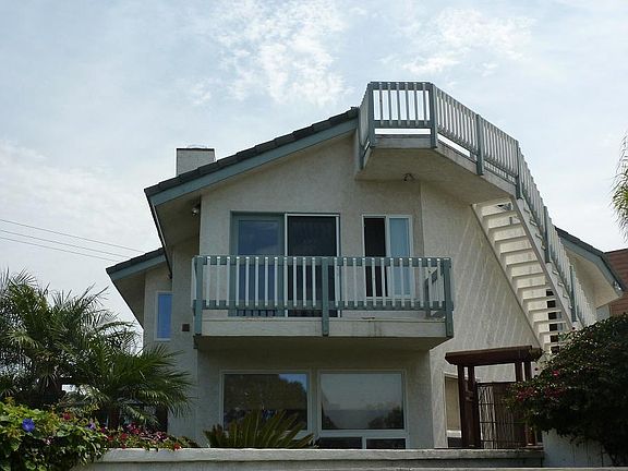 EXTERIOR OF HOME FACING THE OCEAN (WEST). NOTE THE ROOFDECK AND BALCONY OFF MASTER BEDROOM