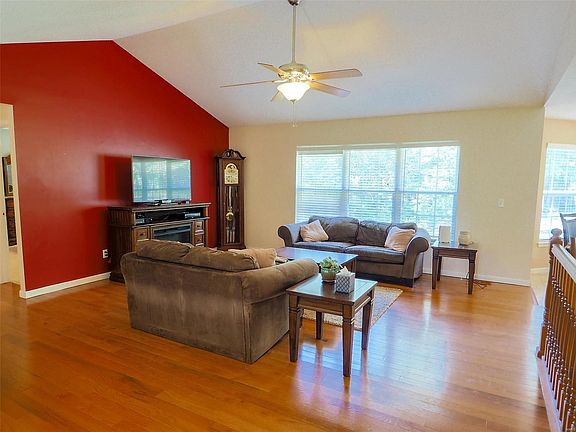 Vaulted ceiling with ceiling fan, large windows that tilt-in, faux wood blinds and freshly painted.