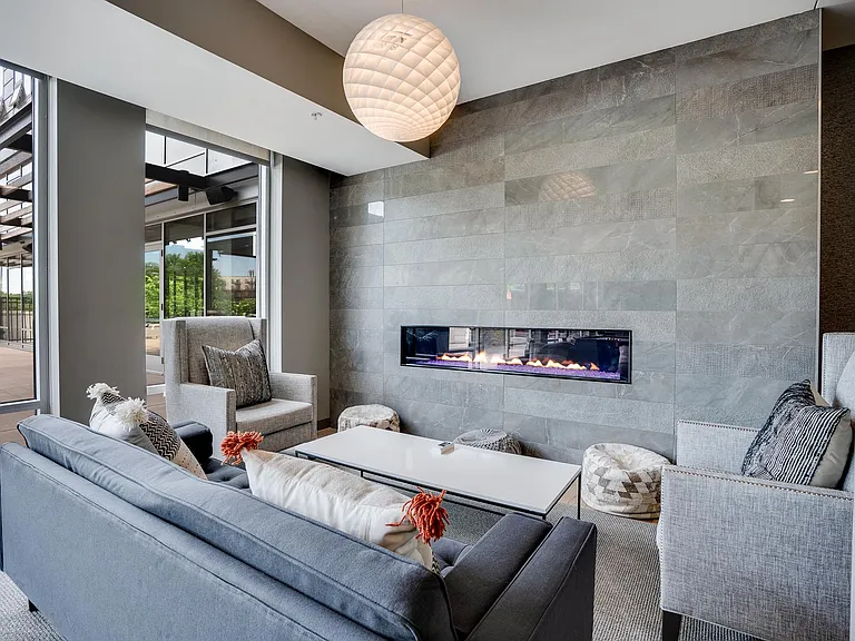 Relax by the fireplace in the clubroom at The Preserve at Normandale Lake