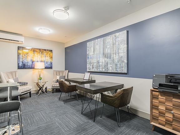 Resident business center with work areas and seating