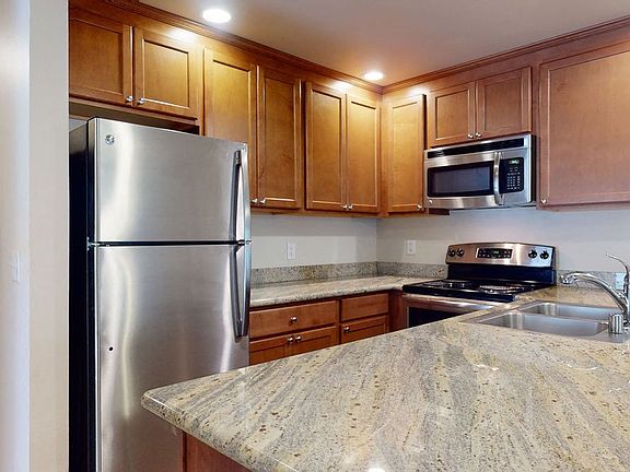 Stunning Kitchen with Stainless steel appliances, lots of counter space and cabinet storage, and a dining area.