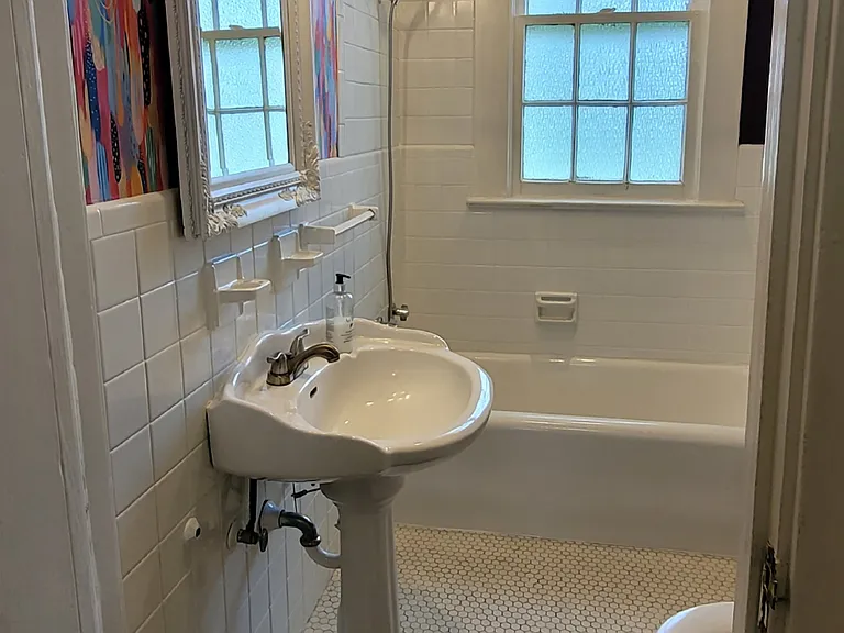 Main bathroom with vibrant accent wall.