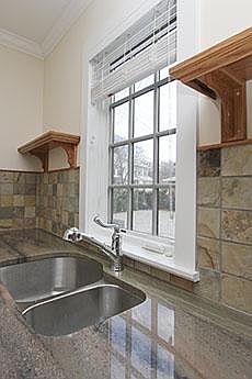 Granite Counter / Tiled Backsplash & Windowed Sink