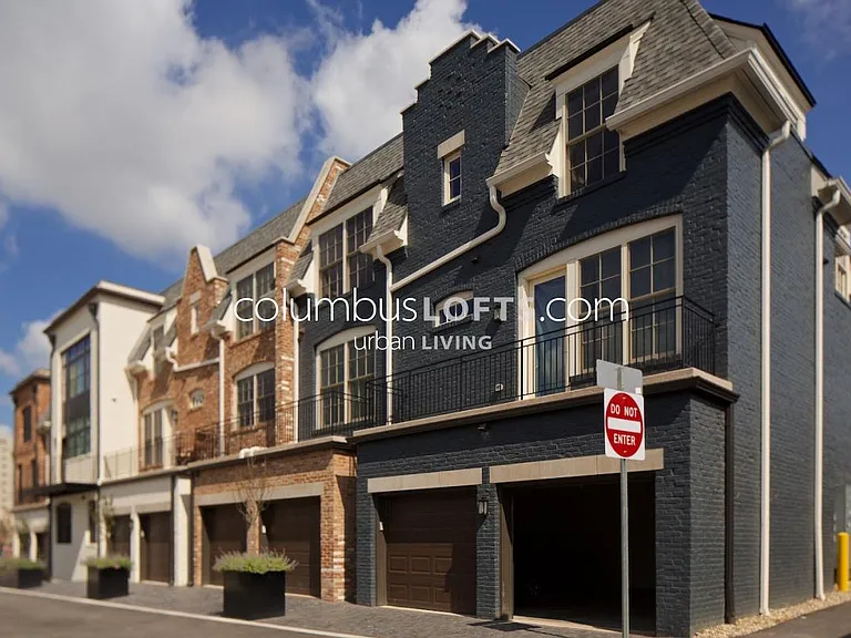 exterior rear of building showing garage and rear balcony outside master bedroom