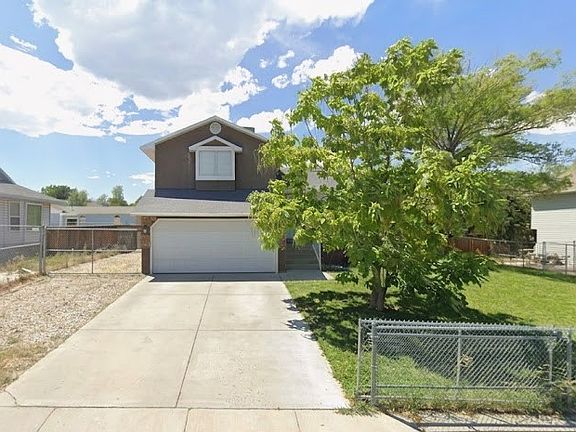 Gravel extends to backyard for additional parking. Gate to closed driveway entrance.