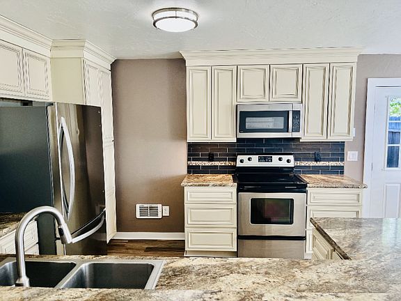 Large open concept living-dining area includes a well appointed kitchen.