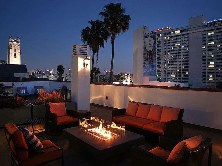 Beautiful nighttime view of rooftop patio with gas firepit and view of Franklin below.