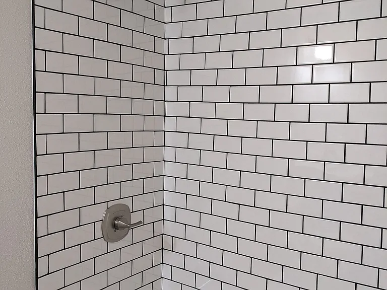 Subway tile in bathtub shower at The Hardison Apartments in Pasadena, California.