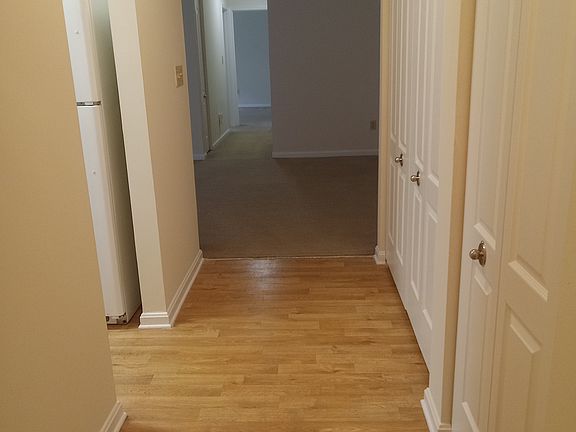 Entry hallway with coat-closet and pantry on rhs and entry to kitchen on lhs
