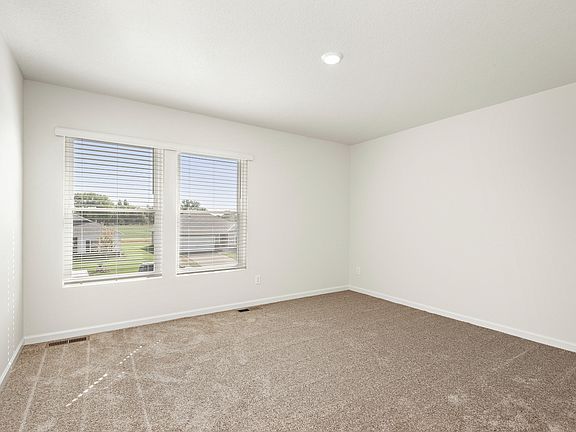 The master bedroom has two large windows and has lots of space.