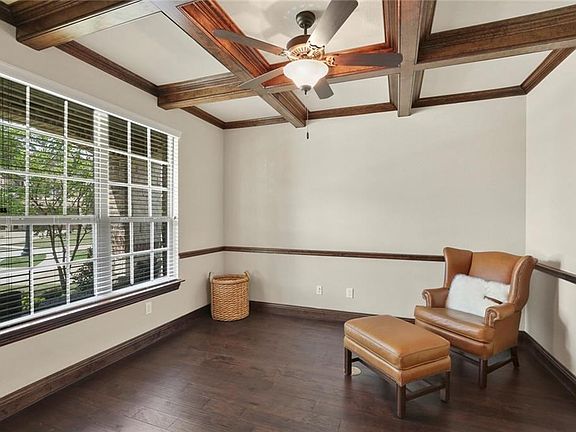 FRENCH DOORS OFF THE FOYER LEAD TO A LARGE PRIVATE STUDY WITH A BEAUTIFUL BEAMED CEILING AND LARGE WINDOWS OVERLOOKING THE FRONT PORCH!