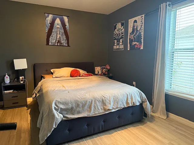 Comfortable bedroom with private en-suite bathroom and natural light.