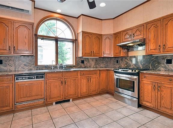 Kitchen with large window and updated appliances.