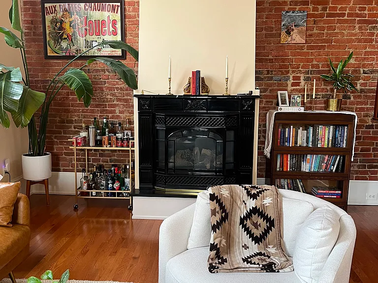 Exposed brick wall and gas fireplace.
