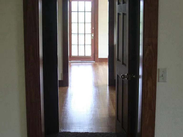 View through from the bedroom to the kitchen, living room and the door to the 12FT x 15FT private balcony.