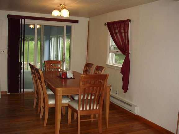 Dining room has beautiful hardwood floors with sliders to the florida room