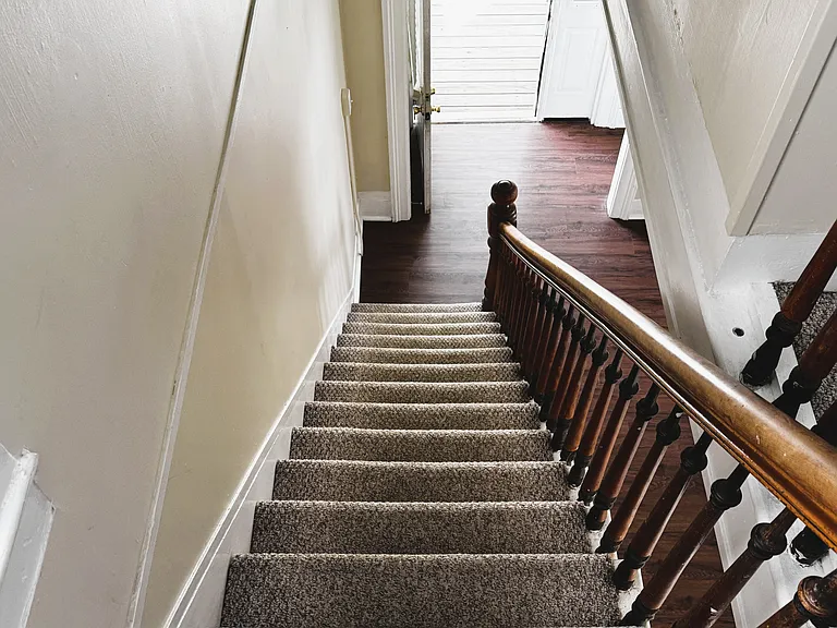 Stairs to 4 bedrooms and full bath upstairs
