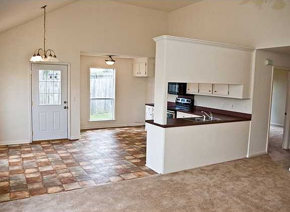 Living room features a cozy fireplace as a focal point.