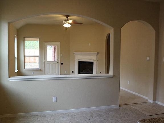 View from kitchen into dining area with living area beyond