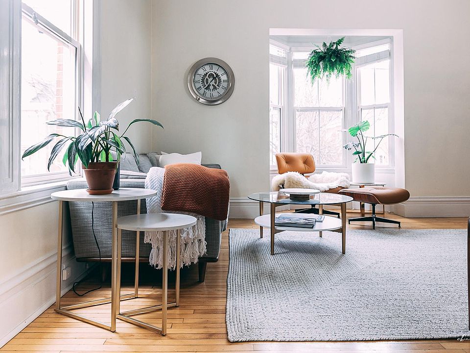 Sunny living room feature a bay window and seating for six.