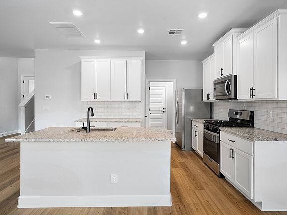 The upgraded kitchen has beautiful sprawling granite countertops.